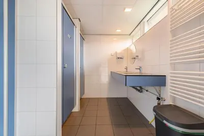 a bathroom with a sink and a toilet at Tiny Camping Pod in Warmond