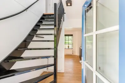 a staircase in a house with a glass wall at Goudkust 4 'Schoorls Geluk' in Schoorl