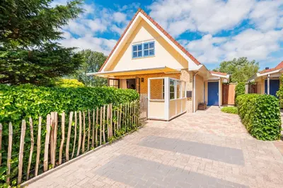 a house with a fence and a gate at Goudkust 4 'Schoorls Geluk' in Schoorl