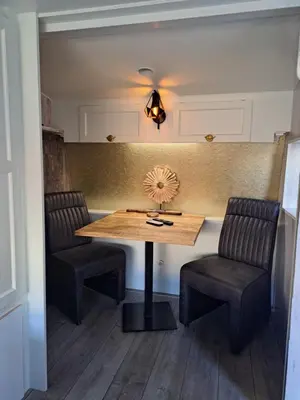 a dining room with a table and two chairs at bnbheerhugowaard in Heerhugowaard