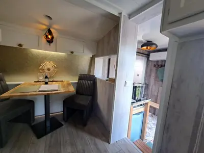 a small kitchen with a table in a tiny house at bnbheerhugowaard in Heerhugowaard