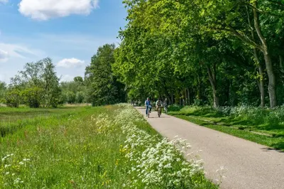 two people walking down a path in a park at EuroParcs Het Amsterdamse Bos in Amstelveen