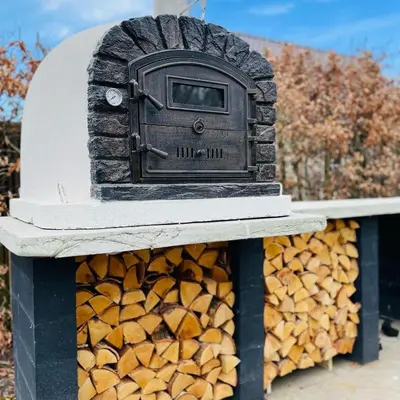 a wood stove with a pile of fire wood at VILLA CALMA Rust Ruimte Luxe inclusief private jacuzzi in Zeewolde