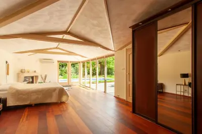 a bedroom with a large bed and a large window at 13P 5B Beautiful villa with heated Pool and Jacuzzi in Heerhugowaard