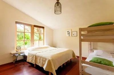 a bedroom with two bunk beds and a window at 13P 5B Beautiful villa with heated Pool and Jacuzzi in Heerhugowaard