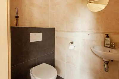 a bathroom with a toilet and a sink at 13P 5B Beautiful villa with heated Pool and Jacuzzi in Heerhugowaard