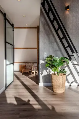 a potted plant in a room with a staircase at Spacious Luxury Loft in Zandvoort