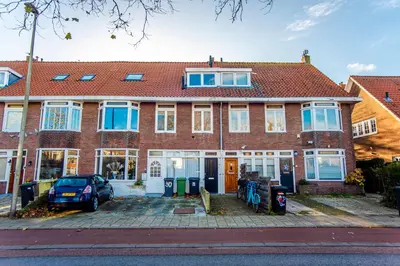 a brick house with a car parked in front of it at Spacious Luxury Loft in Zandvoort