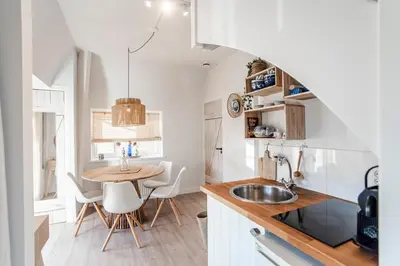 a small kitchen with a table and a sink at South Beach House in Zandvoort