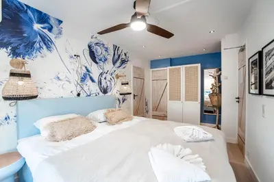 a blue and white bedroom with a large bed at South Beach House in Zandvoort