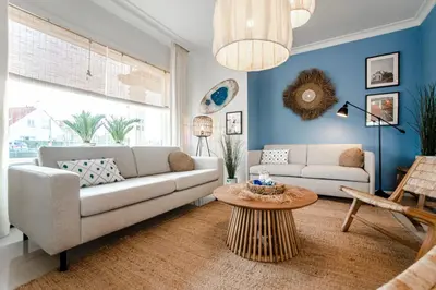 a living room with a couch and a table at South Beach House in Zandvoort
