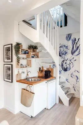 a kitchen with a sink and a staircase at South Beach House in Zandvoort