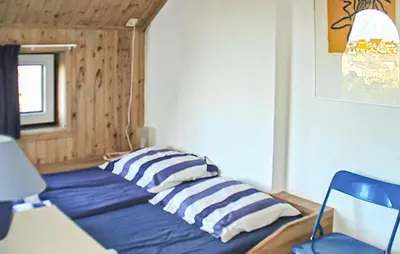 a room with a bed with two pillows on it at Bellevue in Bergen aan Zee