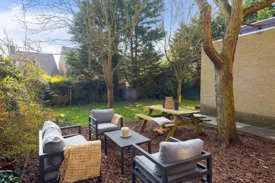 a backyard with a table and chairs and a table and a picnic table at Casa Beach with free parking and garden in Zandvoort