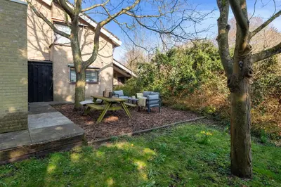 a backyard with a picnic table and chairs at Casa Beach with free parking and garden in Zandvoort