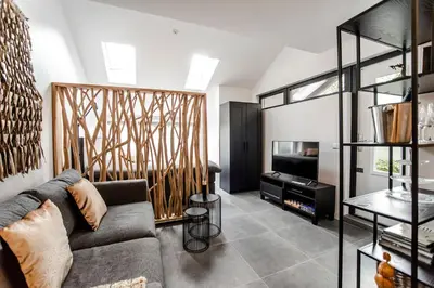 a living room with a couch and a tv at Casa Beach with free parking and garden in Zandvoort