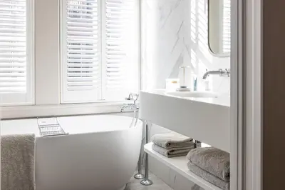 a white bathroom with a tub and a sink at Pillows Grand Boutique Hotel Maurits at the Park - Small Luxury Hotels in Amsterdam