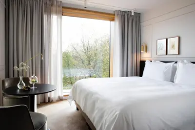 a hotel room with a large bed and a window at Pillows Grand Boutique Hotel Maurits at the Park - Small Luxury Hotels in Amsterdam