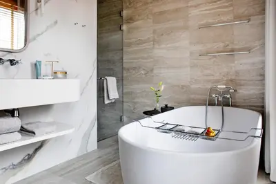a bathroom with a white tub and a sink at Pillows Grand Boutique Hotel Maurits at the Park - Small Luxury Hotels in Amsterdam