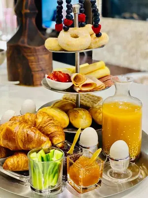 a tray of bread and pastries on a table at Casa De Palmas - Tiny house in Alkmaar
