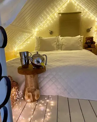 a bedroom with a bed with lights on it at Casa De Palmas - Tiny house in Alkmaar