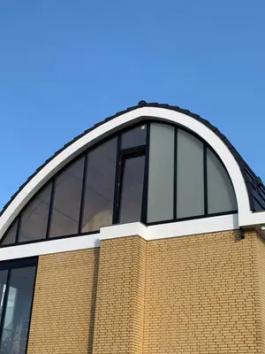 a building with a curved roof on top of it at Penthouse Witsand Zeezicht in Egmond aan Zee