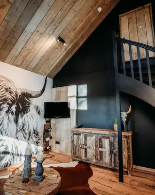 a living room with a tiger mural on the wall at Logement Bilderdam in Leimuiden