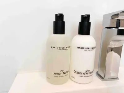 three bottles of hair products sitting on a counter at Little Beach House in Zandvoort