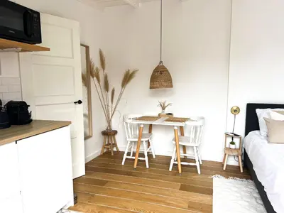 a kitchen and dining room with a table and chairs at Little Beach House in Zandvoort