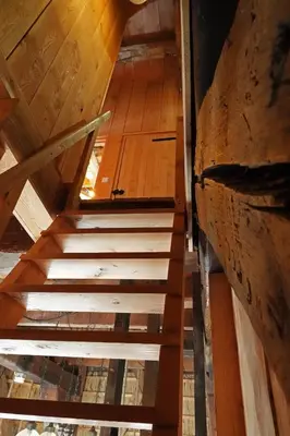 an overhead view of a wooden staircase in a attic at De Molen van Egmond by Droomvilla in Egmond aan den Hoef