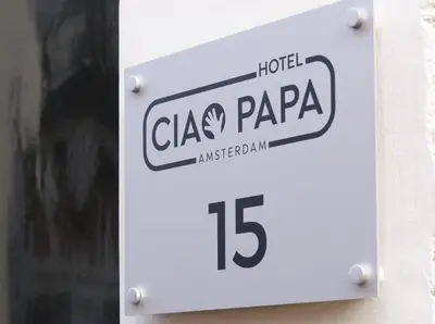 a sign that reads clax papa on a building at Ciao Papa Hotel Amsterdam Central Station in Amsterdam