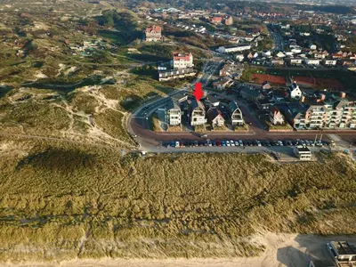 an aerial view of a city with a road at De Platvis in Egmond aan Zee