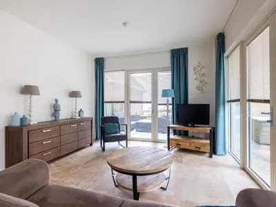 a living room with a couch and a table at De Platvis in Egmond aan Zee