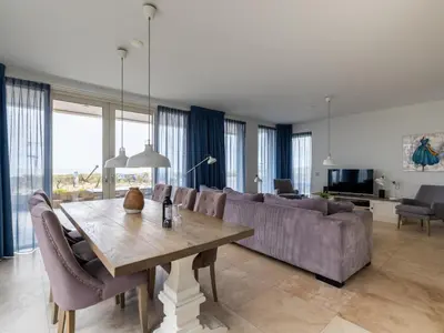a living room with a table and a couch at De Kreeft in Egmond aan Zee