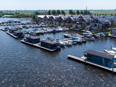 an aerial view of a marina with boats and houses at Tiny houseboat Uitgeest I in Uitgeest