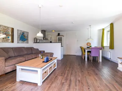 a living room with a couch and a table at Appartement Assum I in Uitgeest