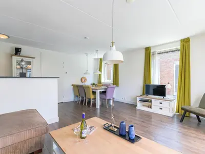 a living room with a couch and a table at Appartement Assum I in Uitgeest