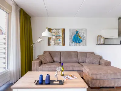 a living room with a couch and a table at Appartement Assum I in Uitgeest