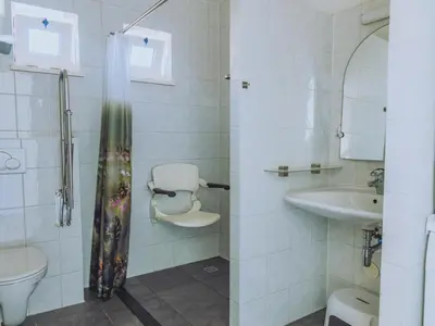 a bathroom with a toilet and a sink at Het Kraaijennest Miva in Uitgeest