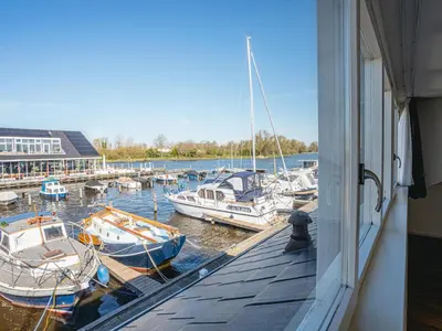 a group of boats are docked at a marina at Het Kraaijennest Miva in Uitgeest