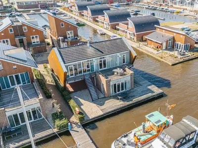 an aerial view of a house on a river at Penthouse in Uitgeest