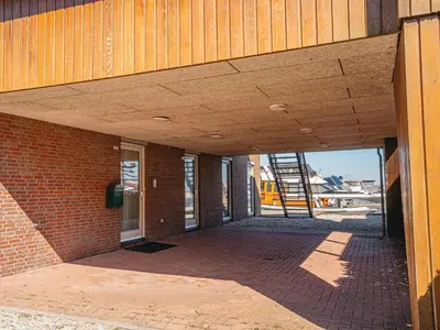 an outside view of a brick building with a wooden ceiling at Penthouse in Uitgeest