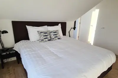 a large white bed with two pillows on it at B&B Het Groene Hart in Nieuwkoop