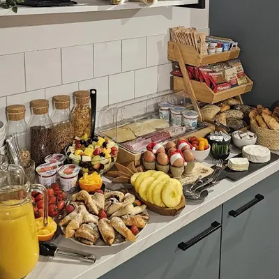 a buffet with many different types of food on a counter at B&B Het Groene Hart in Nieuwkoop
