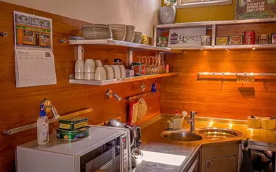 a small kitchen with a sink and a stove at Gunnery's Guest House in Alkmaar