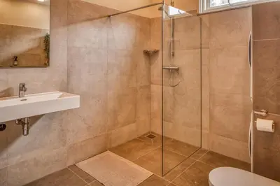 a bathroom with a shower and a sink at Gunnery's Guest House in Alkmaar