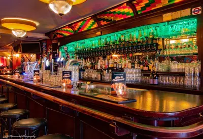 a bar with a lot of bottles of alcohol at Gunnery's Guest House in Alkmaar
