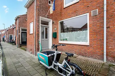 a bike parked in front of a brick building at Studio Evership just minutes from the beach and center in Zandvoort