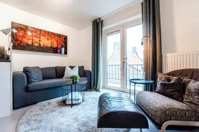 a living room with a couch and a table at Studio Evership just minutes from the beach and center in Zandvoort