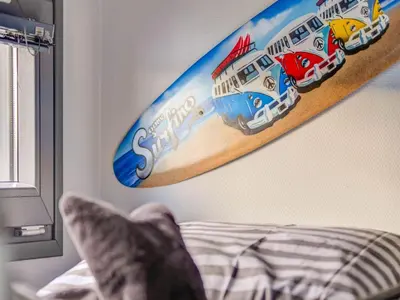 a surfboard hanging on a wall in a bedroom at Houseboat in Volendam near Fort Edam in Volendam